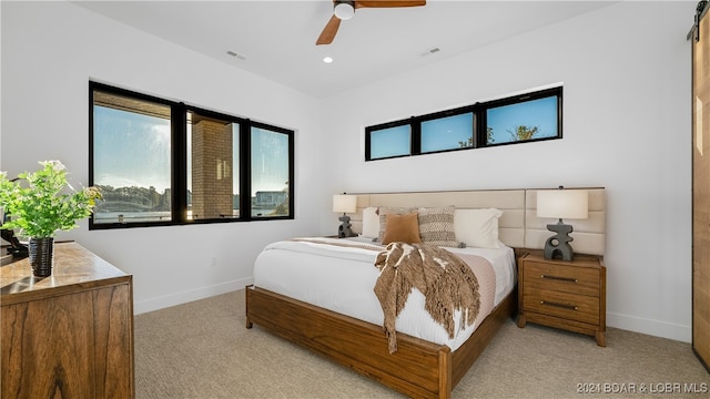 carpeted bedroom with ceiling fan