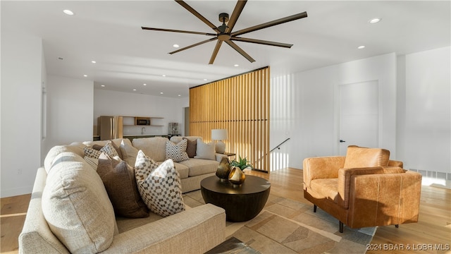 living room with light wood-type flooring and ceiling fan