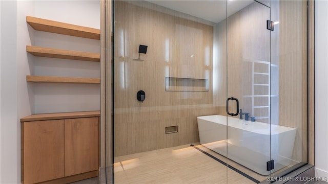 bathroom with separate shower and tub