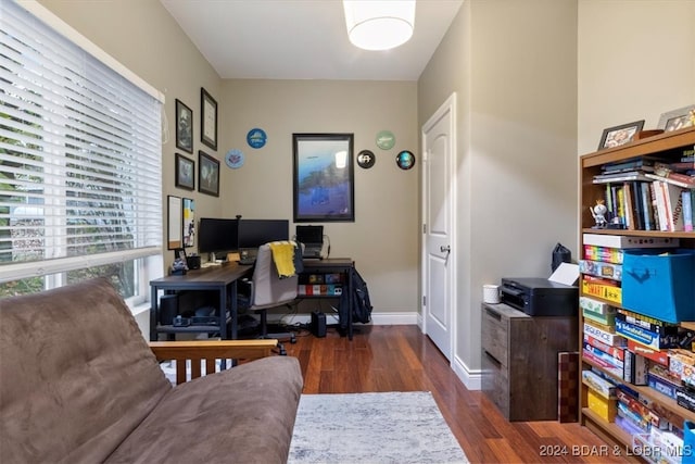 home office featuring plenty of natural light and dark hardwood / wood-style flooring