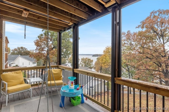 sunroom / solarium with a water view