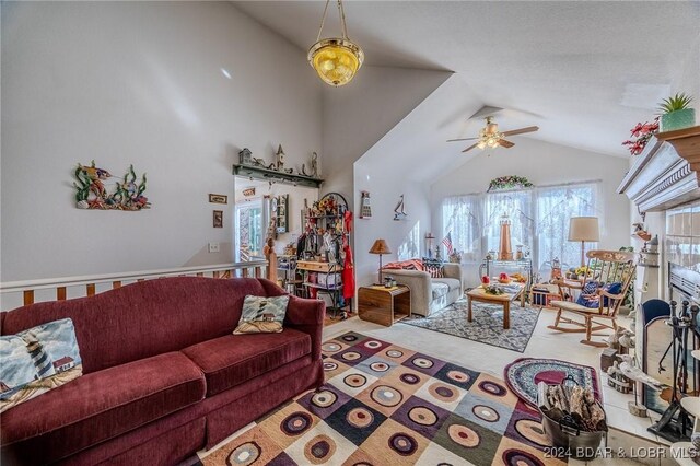 living room featuring ceiling fan and lofted ceiling