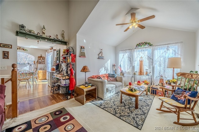 living room with ceiling fan, wood-type flooring, and lofted ceiling