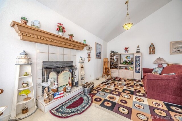 tiled living room with lofted ceiling and a tile fireplace