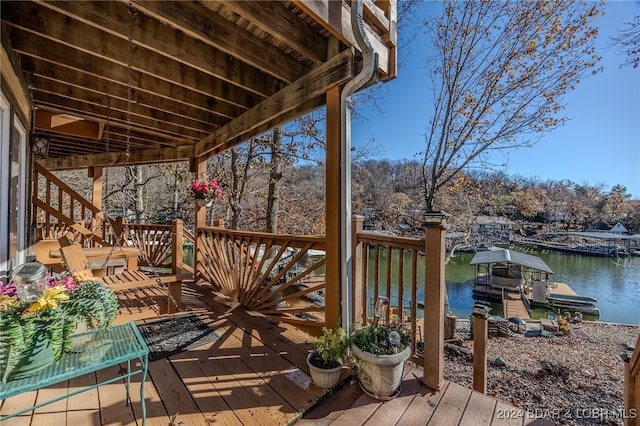 deck with a boat dock and a water view