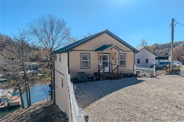 view of front of property with central AC and fence