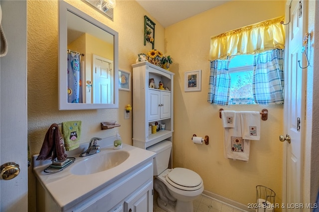 bathroom featuring toilet and vanity