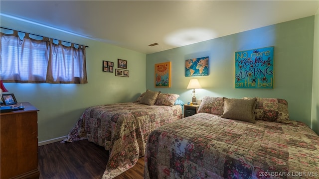 bedroom featuring dark hardwood / wood-style flooring