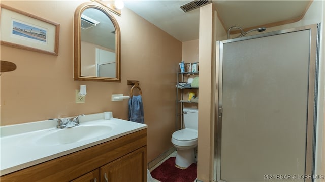 bathroom featuring vanity, toilet, and walk in shower