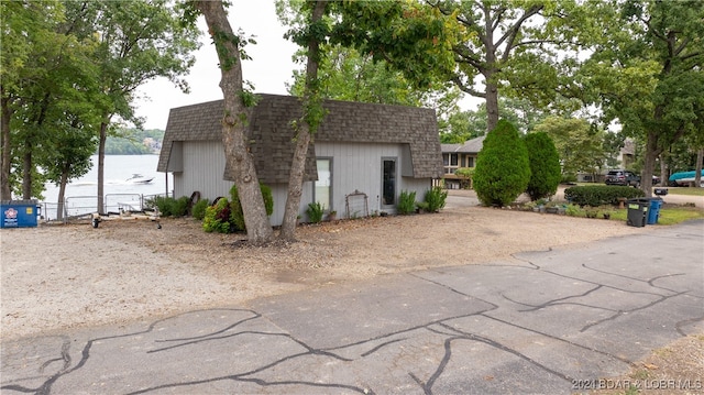 view of side of home featuring a water view