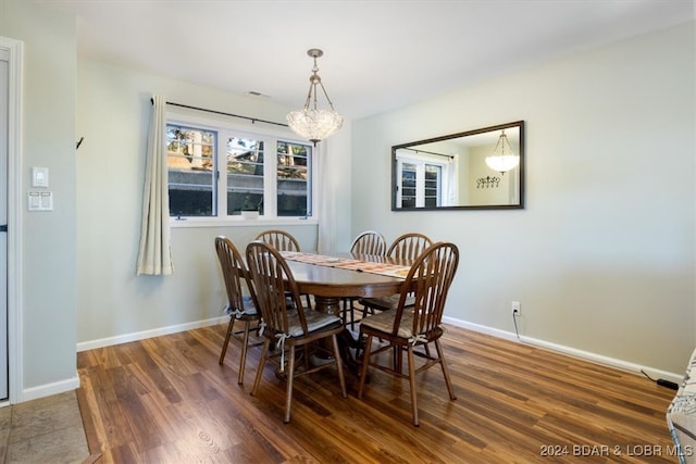 dining room with an inviting chandelier and dark hardwood / wood-style flooring