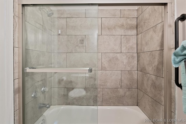 bathroom with shower / bath combination with glass door