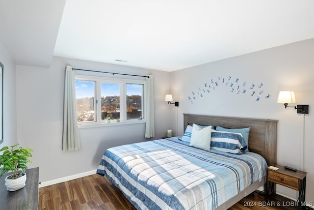 bedroom with dark wood-type flooring