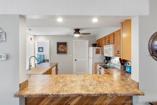 kitchen with white appliances, ceiling fan, sink, and kitchen peninsula