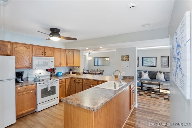 kitchen featuring white appliances, sink, light hardwood / wood-style floors, kitchen peninsula, and ceiling fan