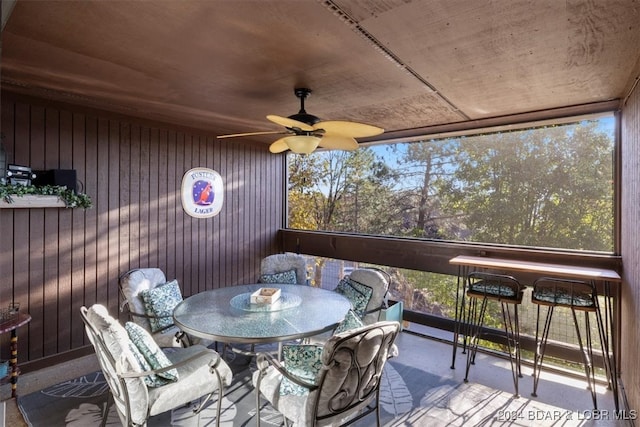 sunroom / solarium featuring ceiling fan