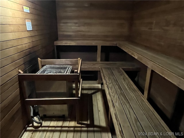 view of sauna with wooden walls and hardwood / wood-style floors