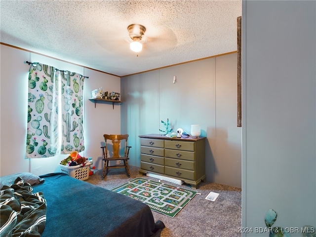 carpeted bedroom featuring ceiling fan, crown molding, and a textured ceiling