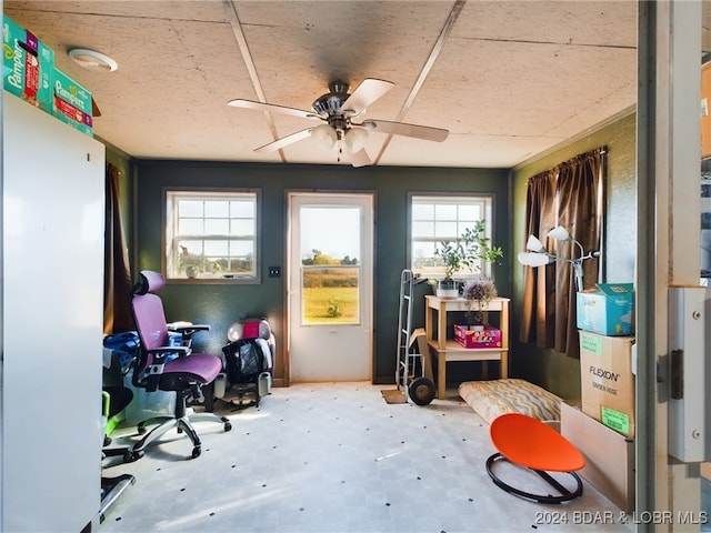 home office featuring a ceiling fan and tile patterned floors