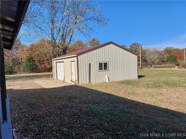 view of outbuilding with a garage and a yard