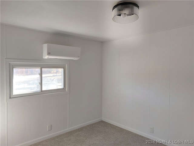 carpeted empty room featuring a wall mounted AC