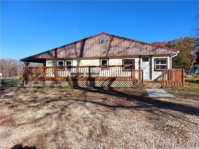 rear view of property with a wooden deck