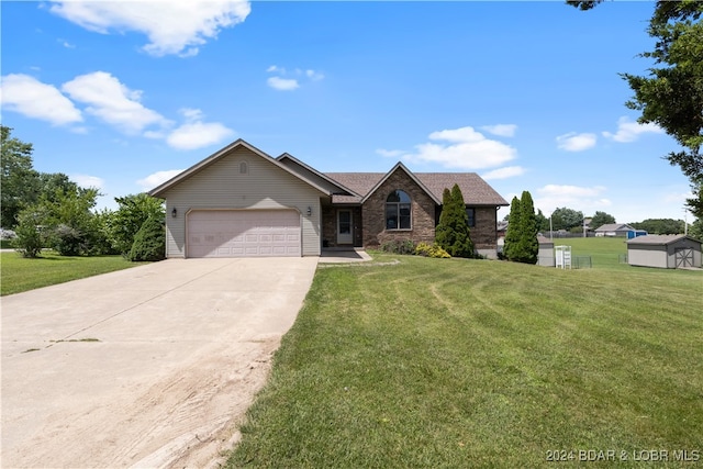 view of front of property featuring a garage and a front lawn