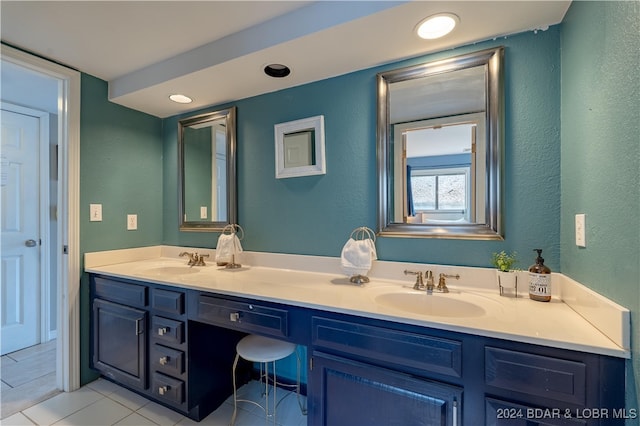 bathroom with tile patterned flooring and vanity