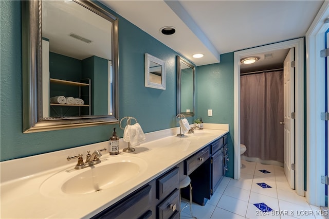 bathroom with tile patterned flooring, vanity, and toilet