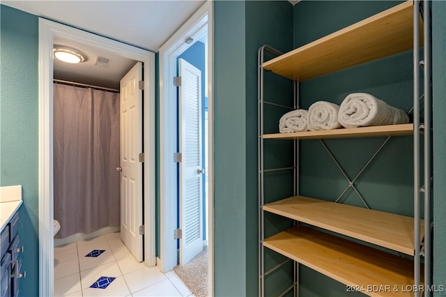 bathroom featuring toilet, vanity, and tile patterned floors