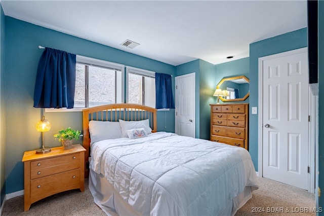 bedroom with light colored carpet