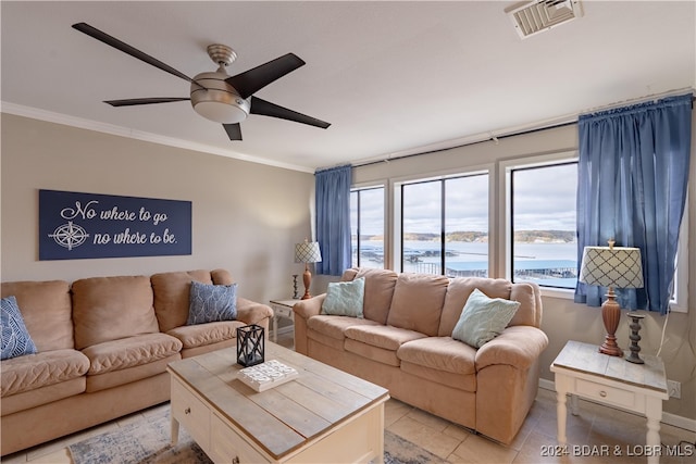 living room with ceiling fan, a water view, light tile patterned flooring, and ornamental molding