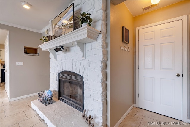 living room with a stone fireplace and ornamental molding