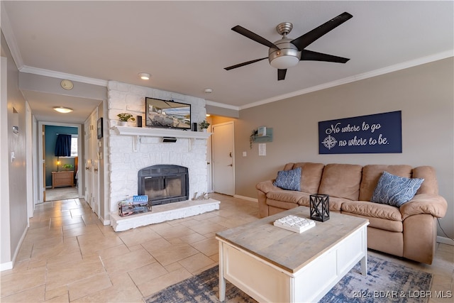 living room with ceiling fan, crown molding, and a fireplace