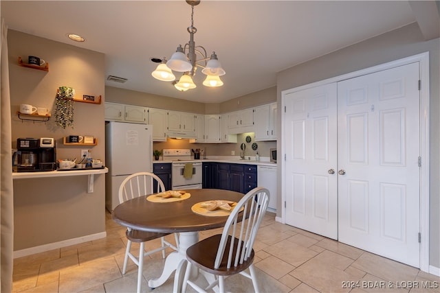 tiled dining space featuring a notable chandelier and sink