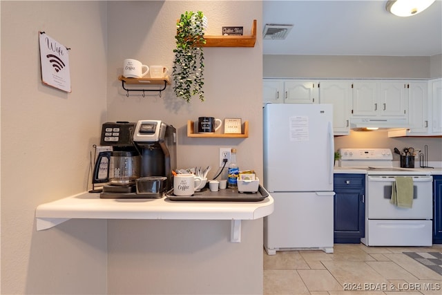 kitchen featuring a breakfast bar, white appliances, white cabinets, blue cabinetry, and light tile patterned flooring