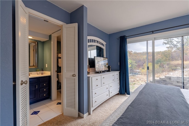 bedroom featuring access to outside, connected bathroom, and light colored carpet