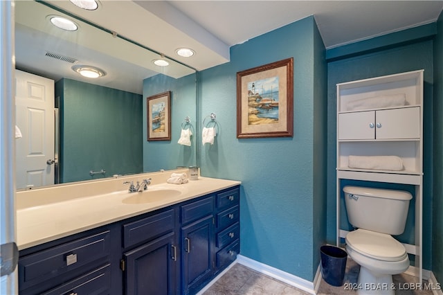 bathroom featuring tile patterned floors, vanity, and toilet