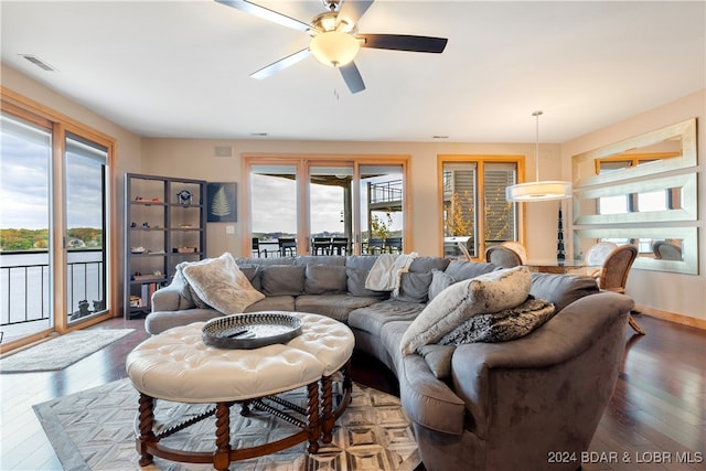 living room featuring ceiling fan, hardwood / wood-style flooring, and a healthy amount of sunlight