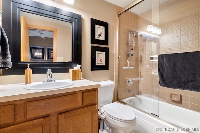 full bathroom with vanity, toilet, and combined bath / shower with glass door