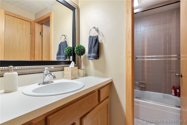 bathroom featuring enclosed tub / shower combo and vanity