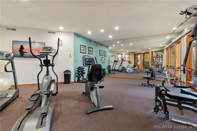 gym featuring a textured ceiling