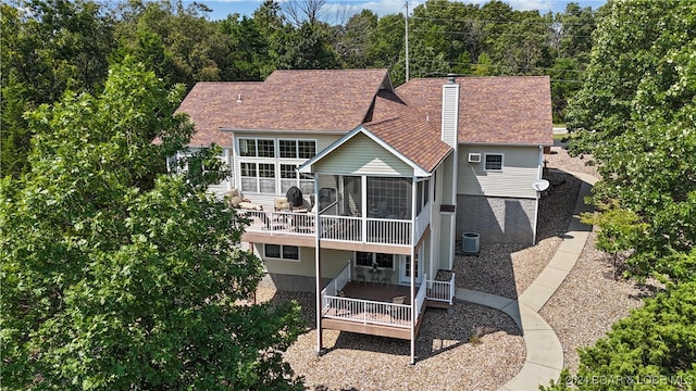 back of property featuring central air condition unit and a sunroom