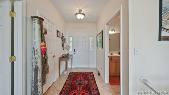 entryway featuring sink and light tile patterned floors