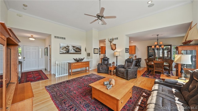 living room featuring hardwood / wood-style floors, ceiling fan with notable chandelier, and crown molding