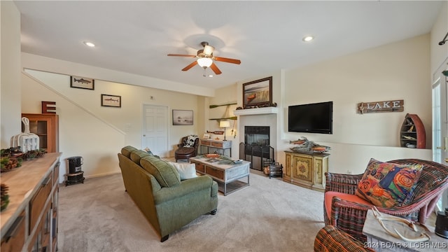 carpeted living room featuring ceiling fan