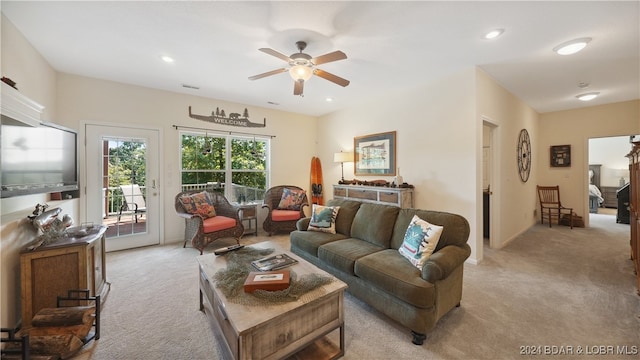 living room with light colored carpet and ceiling fan