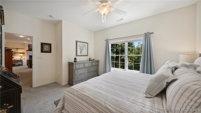 carpeted bedroom featuring ceiling fan