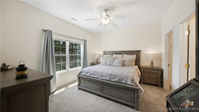 bedroom with ceiling fan and light carpet