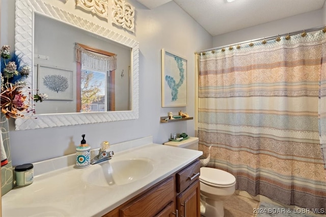 bathroom with tile patterned flooring, vanity, toilet, and walk in shower